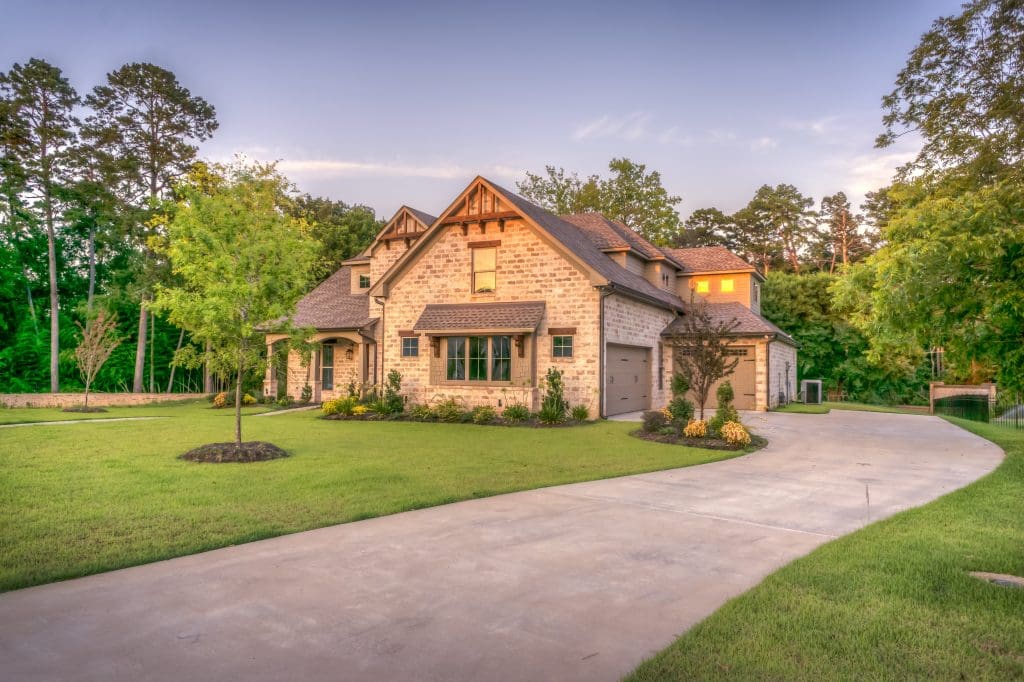 Selling Your Home, Part 2: When Is the Best Time to List My Property? 3 A beautiful home sits at the end of its driveway, lit by the afternoon sun.