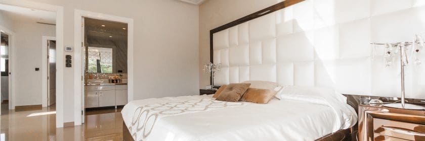 modern bedroom with zebra carpet and king-sized bed with fresh, white linen