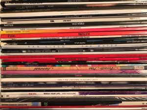 Stack of dozens of vinyl records in their sleeve