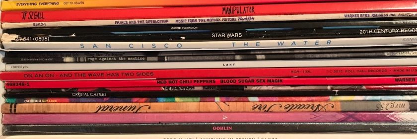Stack of dozens of vinyl records in their sleeve