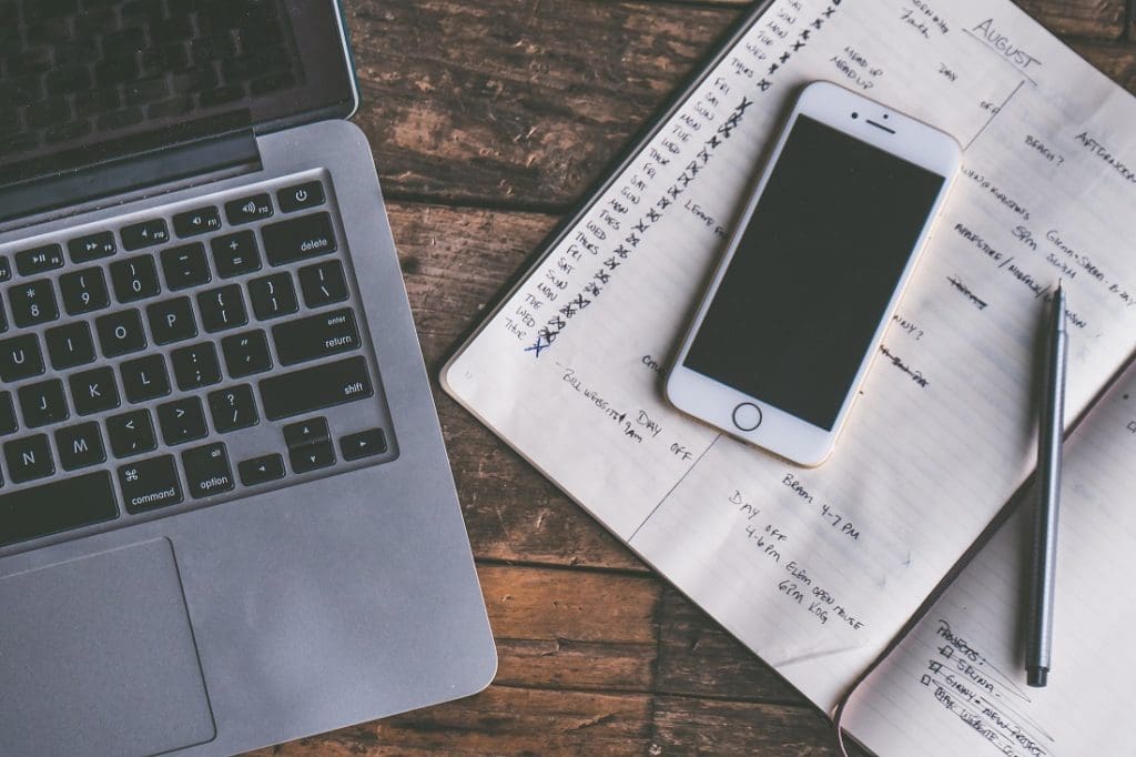 How to Plan a Move in 8 Weeks (Or Less!) 4 Computer, notebook, and phone on a desk