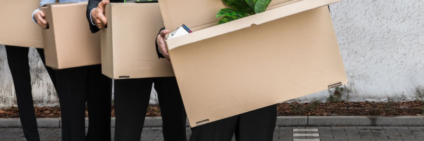 Employees carrying their personal office belownings in preparation for the office relocation.