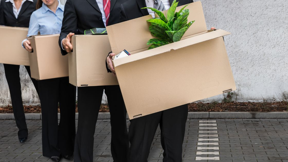Employees carrying their personal office belownings in preparation for the office relocation.